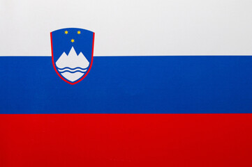 Slovenia flag depicted on folded wavy fabric of old cloth close up