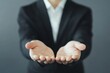 © Andrii - A business professional extending hands forward in a welcoming gesture against a neutral background
