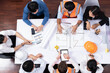 © Summit Art Creations - Top view banner of diverse group of civil engineer and client working together on architectural project, reviewing construction plan and building blueprint at meeting table. Prudent