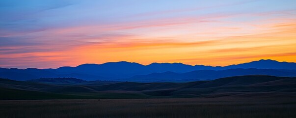 Wall Mural - Sunset over rolling hills with vibrant colors