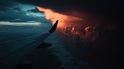 Wall Mural - A dramatic view from an airplane wing, showcasing vibrant clouds and sunset hues.