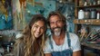 © Dmitry - Two joyful artists pose together in a vibrant studio, showcasing their creativity and passion for art amidst a backdrop of colorful paintings