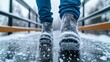 © fotogurme - Person slipping on an icy sidewalk holding onto a railing winter safety issues fall risk