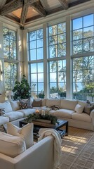 A living room filled with white furniture and large windows