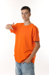 Wall Mural - Teenage boy wearing orange t-shirt on white background