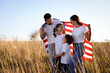 © New Africa - Happy family with flag of USA outdoors. Space for text