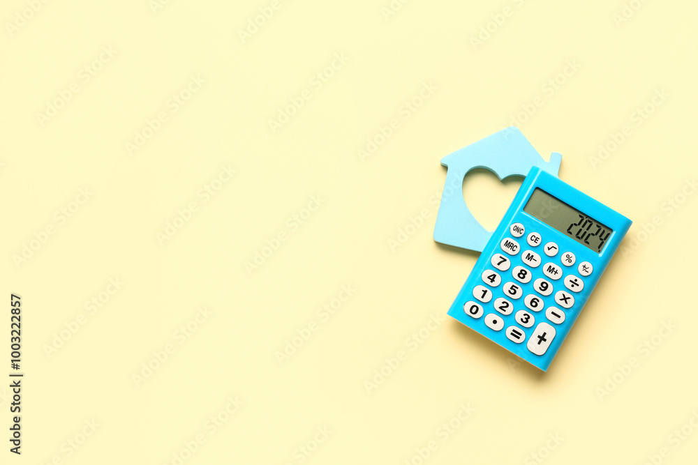 Calculator with number 2024 and decorative house on yellow background