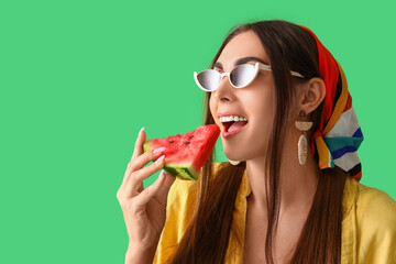 Canvas Print - Young woman eating fresh watermelon on green background, closeup