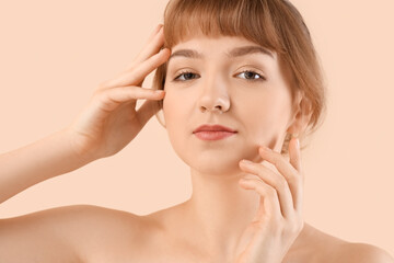 Canvas Print - Beautiful young woman on beige background, closeup