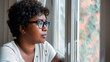 © VicPhoto - Pensive young woman with glasses looking out the window