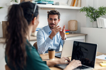 Business people discussing together in conference room during meeting at office.