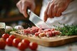 © itchaznong - A chef is cutting meat on a wooden cutting board