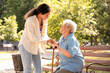 © Pixel-Shot - Young African-American female medical worker helping elderly woman outdoors
