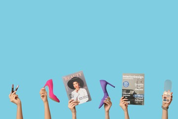 Poster - Female hands with different magazines, high heels, lipsticks and palette of eyeshadows on blue background