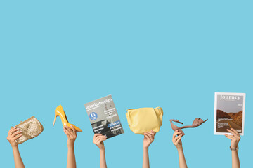 Sticker - Female hands with different magazines, high heels and stylish bags on blue background