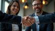 © Augusto - Business partners shaking hands after securing startup funding