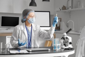 Poster - Female scientist working with Petri dish at table in laboratory