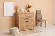 © Pixel-Shot - Comfortable pouf, lamp and wooden chest of drawers in living room