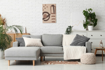 Canvas Print - Sofa, pouf, houseplant and coffee table in interior of living room