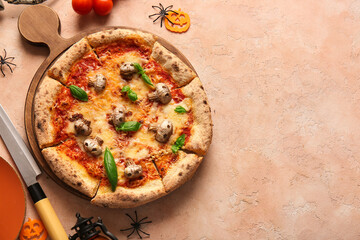 Wooden board of tasty pizza with mushrooms and spiders for Halloween celebration on beige background