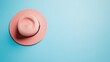 © Artyom - Pink straw hat on light blue background