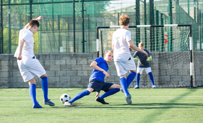 Teens playing soccer football match. Competition between two youth soccer teams. Football soccer tournament