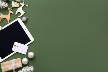 Poster - Composition with tablet computer, credit card and beautiful Christmas decorations on green background