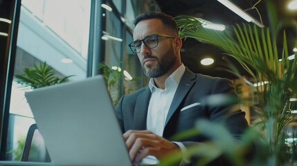 Canvas Print - Professional Man Working on Laptop in Modern Office