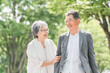 © buritora - 公園を歩くシニア・高齢者夫婦（楽しい・爆笑・笑顔・リフレッシュ）