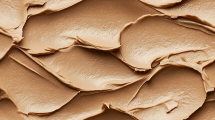 a close-up, top-down view of hazelnut butter spread across the frame, filling the image with its light brown hue and smooth, thick texture