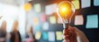 © Gpeg26 - A bright idea emerges amidst a backdrop of brainstorming, symbolized by a glowing light bulb held in a hand against a wall filled with sticky notes