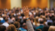 © Andres Mejia - Businessman raising hand asking question during conference meeting