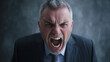 © Andres Mejia - Angry senior businessman screaming at someone off camera