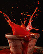 © DriftlessRamblings93 - Rustic tomato splash; rich red liquid, wild motion, glossy texture contrasts with dark backdrop.