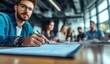 © logitech - A businessman in glasses sits at a conference table with his team, taking notes during a meeting.