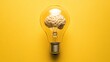 © vetrana - Light bulb with brain inside on yellow background symbolizes innovation and power of ideas
