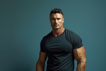 Wall Mural - muscular man presenting with confidence against a solid color backdrop, showcasing his fit body and 