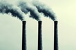 © ItziesDesign - Three smokestacks emitting smoke against a grey sky, symbolizing industrial pollution and environmental impact.