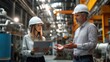 © Old Man Stocker - Engineering Discussion in Industrial Setting. Woman and a man engage in a professional discussion in an industrial environment, showcasing teamwork and collaboration in engineering and technology.