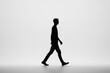 © Alex - Silhouette of a man walking on gradient background.