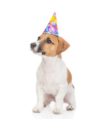 Aufkleber - Cute Jack russell terrier puppy wearing party cap sits and looks away and up on empty space. isolated on white background