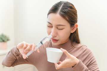 Close-up shot of woman cleaning her nasal.