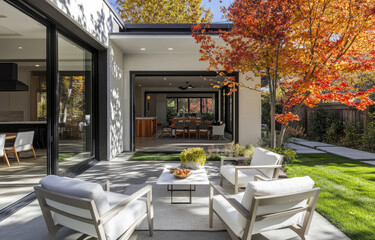 Wall Mural - the front porch with an outdoor seating area, featuring white chairs and a table on a concrete floor in a modern farmhouse-style house