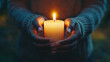 © Worakit - person holding lit candle symbolizes solemn moment, evoking feelings of reflection and tranquility. warm glow of candlelight creates serene atmosphere
