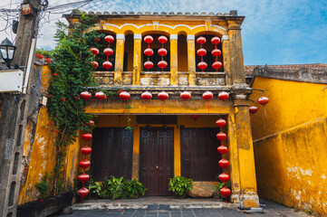 The facade of a traditional ancient yellow house on the streets of the old city in Hoi An in Vietnam