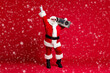 © deagreez - Full body size photo of retired old man grey beard hold boombox shoulder point finger up street dance wear santa costume sunglass headwear leather black boots isolated red color background