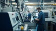 © fotofabrika - Skilled worker operating machinery in a modern manufacturing facility during an industrial production shift