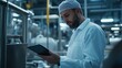 © fotofabrika - Scientist examining data on a tablet in a modern laboratory during the day