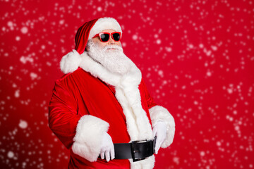 Wall Mural - Photo of retired old man grey beard hands belt self-assured prepare save christmas eve spirit protector wear santa costume gloves coat sunglass headwear isolated red color background