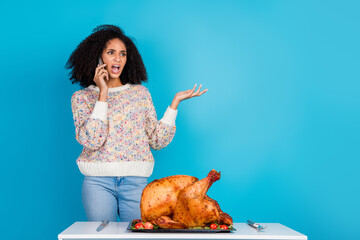 Canvas Print - Photo of attractive young woman irritated talk phone argument celebrate thanksgiving dinner turkey isolated on blue color background